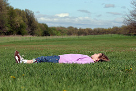 Girl lying on the grass with her eyes closed