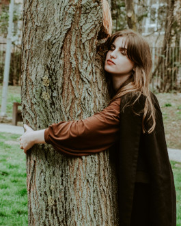 Young lady embracing the tree