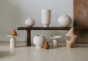 Sculptural artwork of ceramic vases in white, grey, and brown colors