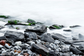 Black and grey stones in the foggy water